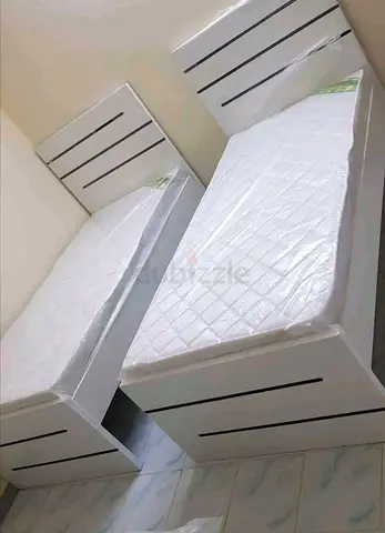 Pair of single beds with mattresses - white wooden frames