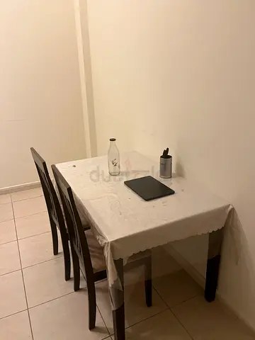 Compact dining table with 2 chairs - dark wood frame, white tablecloth