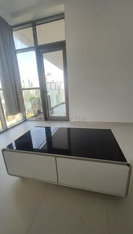 Modern White and Black Coffee Table with a fridge and speaker