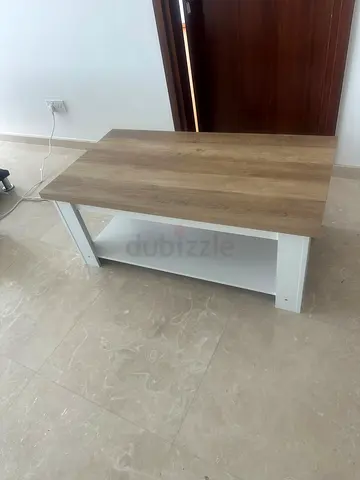 Simple wooden coffee table with lower shelf - good condition