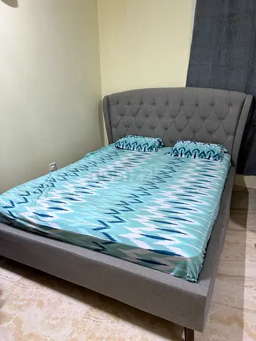Grey upholstered double bed frame with tufted headboard - good condition