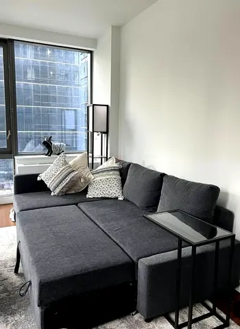 Dark Grey L-Shaped Sofa Bed with Ottoman - Good Condition