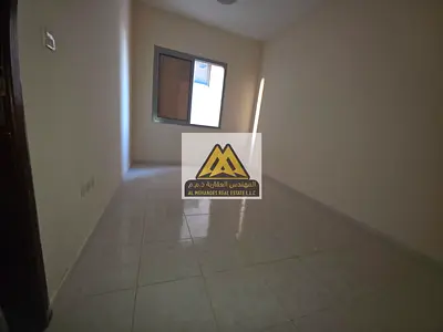 A spacious 1-bedroom apartment available for annual rent in Al Nuaimiya 1, Ajman, featuring a separ