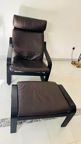 Ikea Poang dark brown leather lounge arm chair with matching footstool.