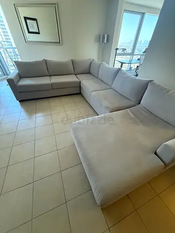 Light grey fabric sectional sofa with chaise