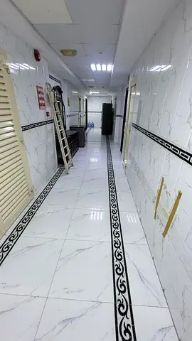 For rent in Al Nabba, Sharjah: One-bedroom apartment with a living room, balcony, central air conditioning, bathroom, and kitchen. Annual rent is AED