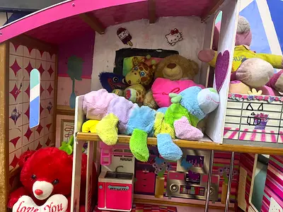 Large Wooden Dollhouse with Assorted Soft Toys - Good Condition with little tear here and there.