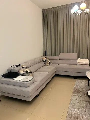 Light grey L-shaped sectional sofa in good condition