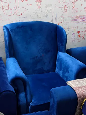 Comfortable blue velvet wingback armchair