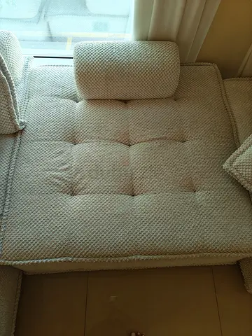 Comfortable Cream Textured Sofa Section with Bolster Pillow