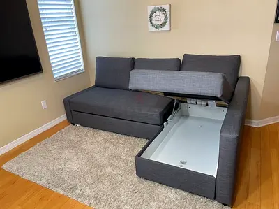 Grey L-shaped sofa bed with storage - good condition