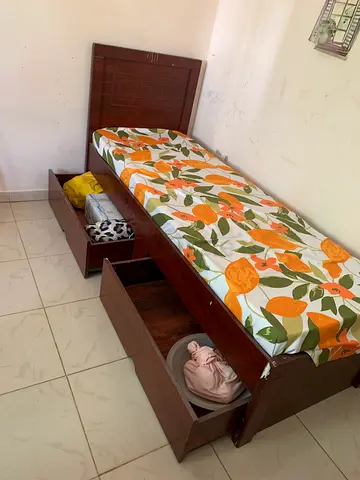 Single wooden bed with under-bed storage and headboard