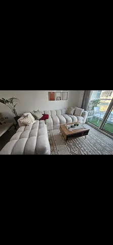 L-shaped tufted beige fabric sectional sofa — comfortable 4-seater