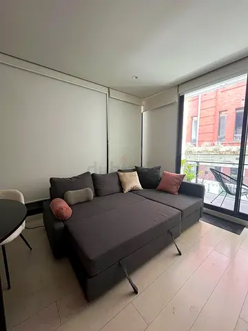 Dark grey L-shaped sofa bed with chaise lounge