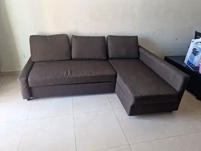 Dark brown L-shaped Ikea sofa bed with storage — good condition