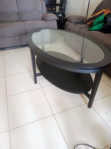 Oval glass coffee table with black frame