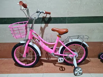 Pink kids bicycle with training wheels, basket and rear rack - good condition