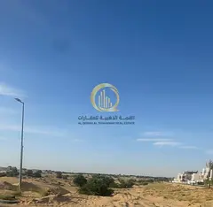 Residential land for sale in Sharjah, Al Hooshi area (new development), prime corner location on two