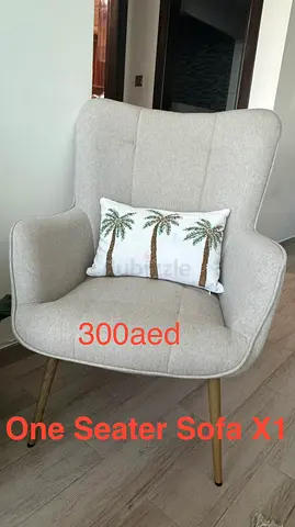 Light grey one-seater accent chair with wooden legs - 300 AED