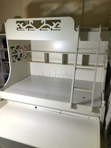 White wooden bunk bed frame with built-in shelves and underbed