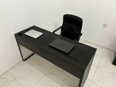 Used executive office desk with swivel chair — dark wood finish