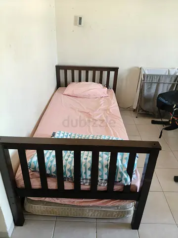 Single dark wood bed frame with mattress