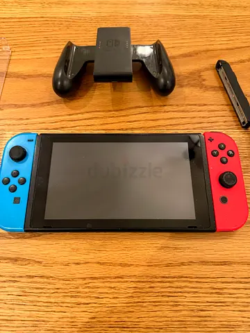 Nintendo Switch console with Joy-Con controllers and grip - excellent condition