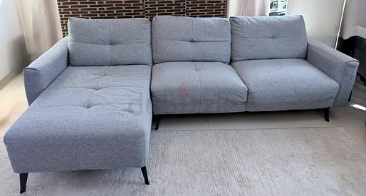 Light grey L-shaped 3-seater fabric sofa-bed with chaise