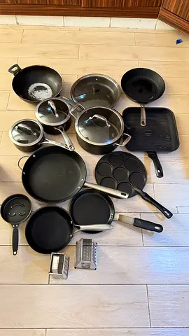 Mixed set of used non-stick pots, pans and cookware.