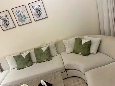 Light Beige Curved Corner Sofa with Ottoman - Good Condition