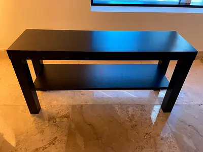 Simple black console table with lower shelf
