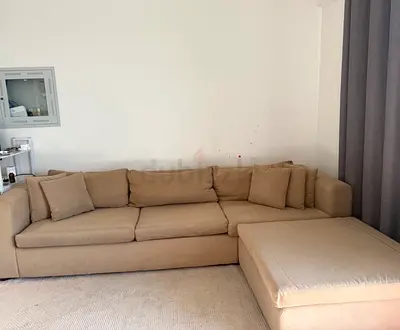 Comfortable Beige L-Shaped Sectional Sofa with Cushions