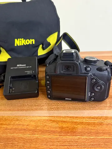 Nikon DSLR with charger and Nikon camera bag - used