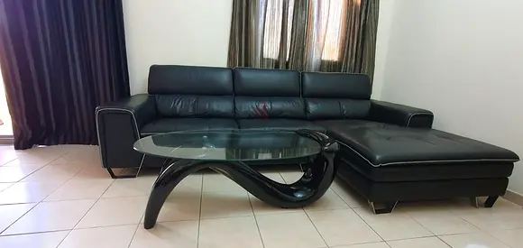 Home Centre L shape 3 seater leather sofa with adjustable head rest and Glass top Center table