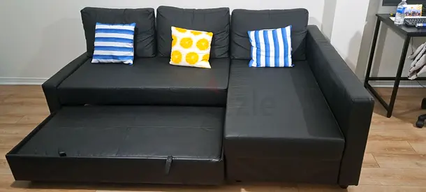 Black L-shaped Sofa with Pull-out Bed and Cushions