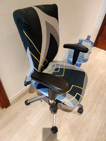 Used ergonomic office chair with adjustable armrests