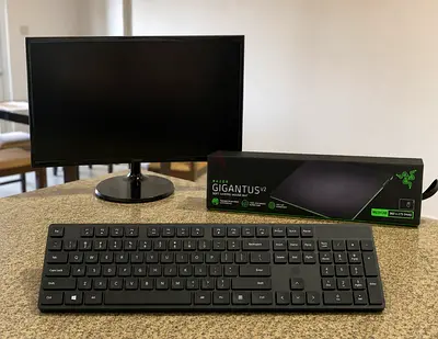 Samsung Computer Monitor, HP Keyboard, Razer Mat