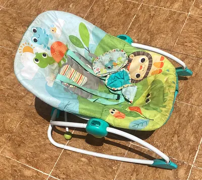 Baby bouncer rocker seat with playful animal print
