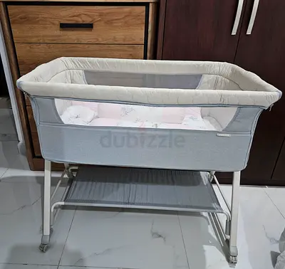 Light grey bedside bassinet with storage shelf - good condition