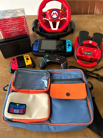 Nintendo Switch console bundle with controllers, steering wheel, games and carry bag