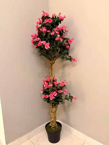 Tall artificial pink flowering plant in black pot - good condition