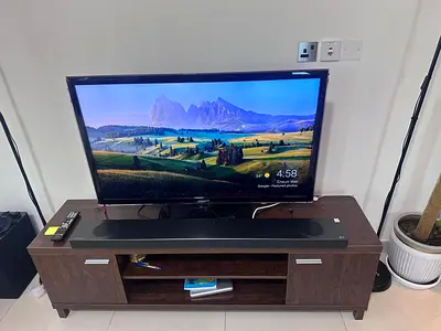 32-inch Smart LED TV with Soundbar - Good Condition with Stand