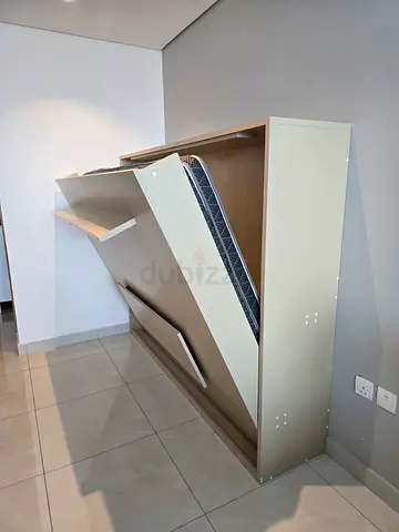 Wall-mounted folding bed (Murphy-style)