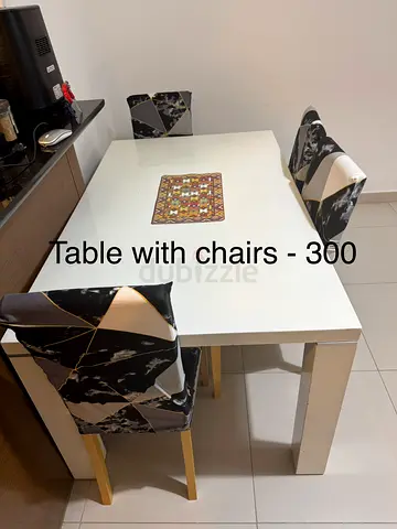 White dining table with 4 patterned chairs - good condition