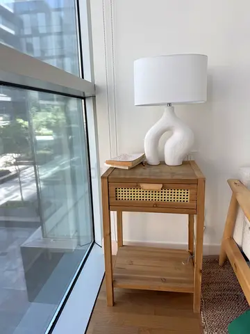 Solid wood bedside table with drawer and shelf - light oak finish.