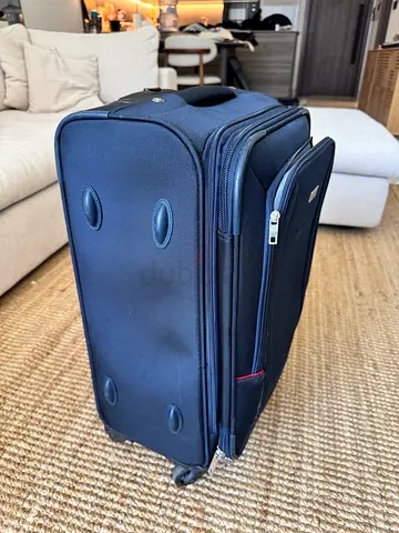 Medium blue navy soft-shell roller carry on luggage with expandible compartment