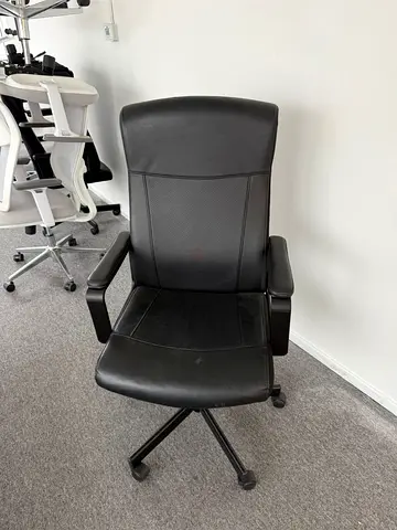 Used black leather office chair with armrests and wheels