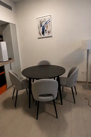 Round Black Dining Table with 4 Grey Upholstered Chairs