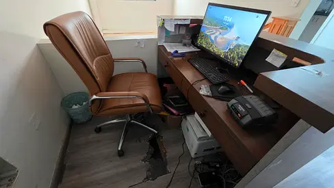Office reception desk setup with chair