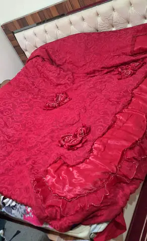 Queen size red quilted bedspread with rose appliqués